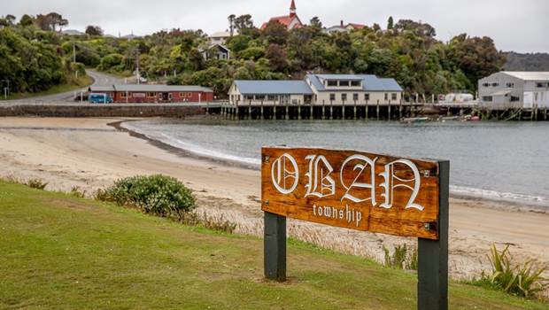 The sign for Oban Township stands at the entrance to the beach on Stewart Island