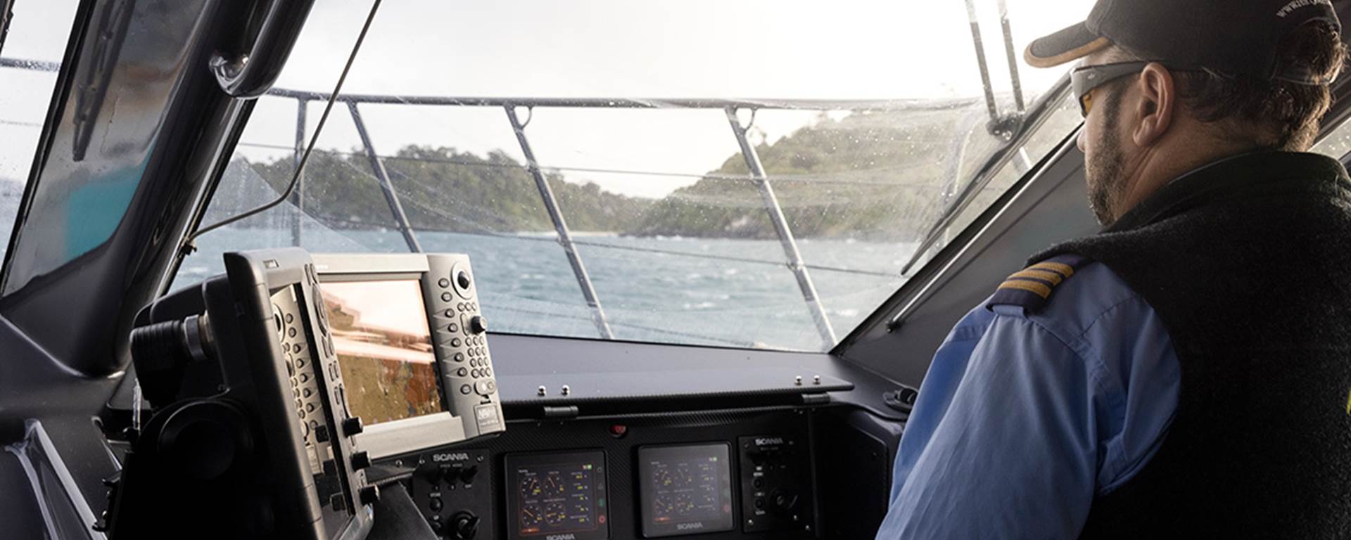 Skipper looks toward Stewart Island while in the wheelhouse of the ferry