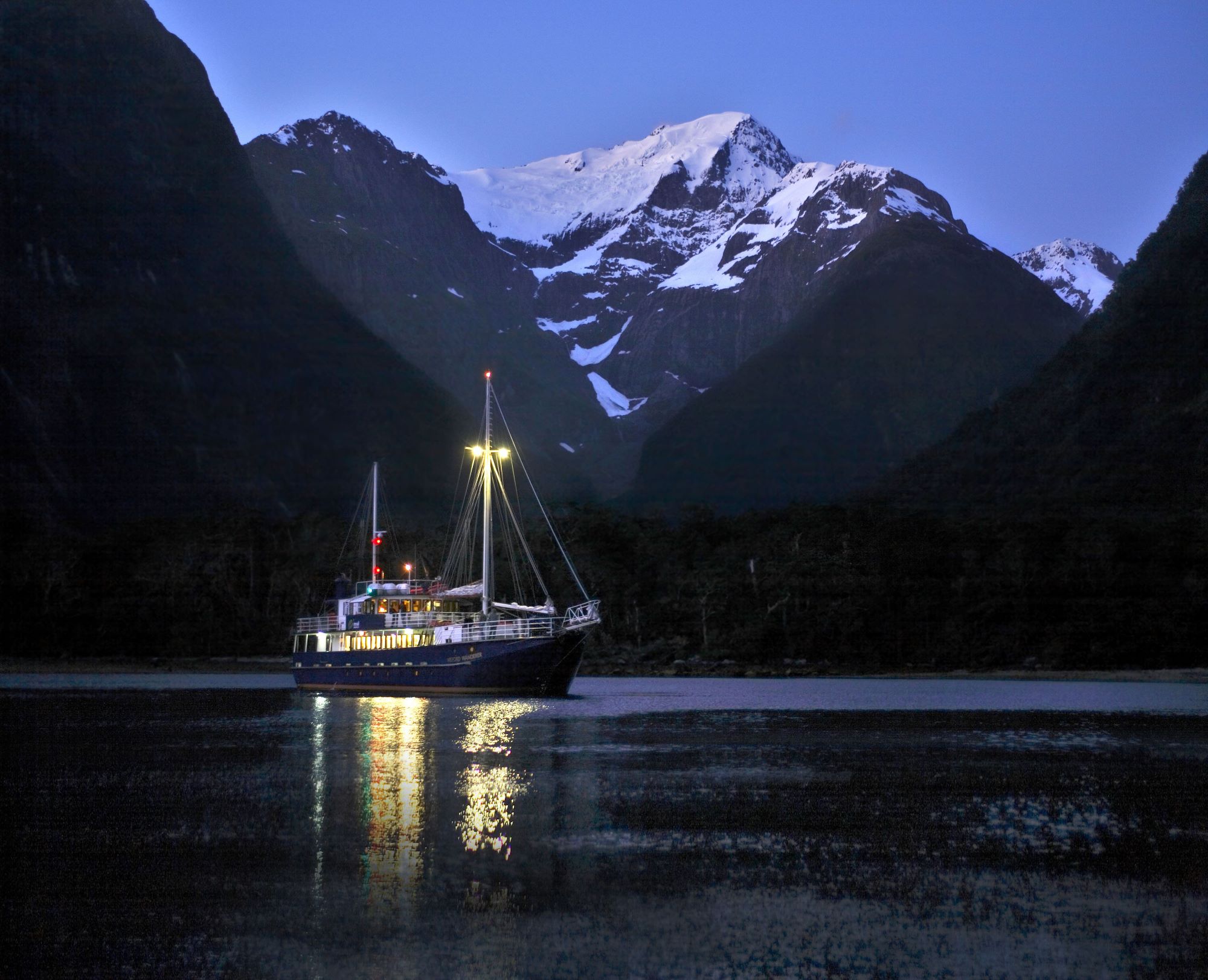 Boat on Milford Sound at night