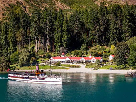 Vintage Steamship, TSS Earnslaw on Lake Wakatipu in front of the Colonel's Homestead at Walter Peak High Country Farm