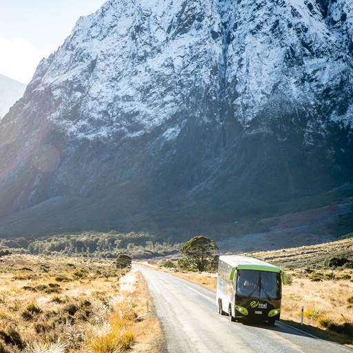 Coach on the way to Milford Sound with snow capped mountains