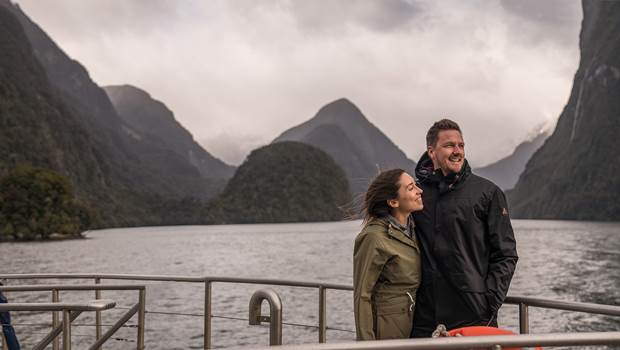 Couple on front of boat in Doubtful Sound