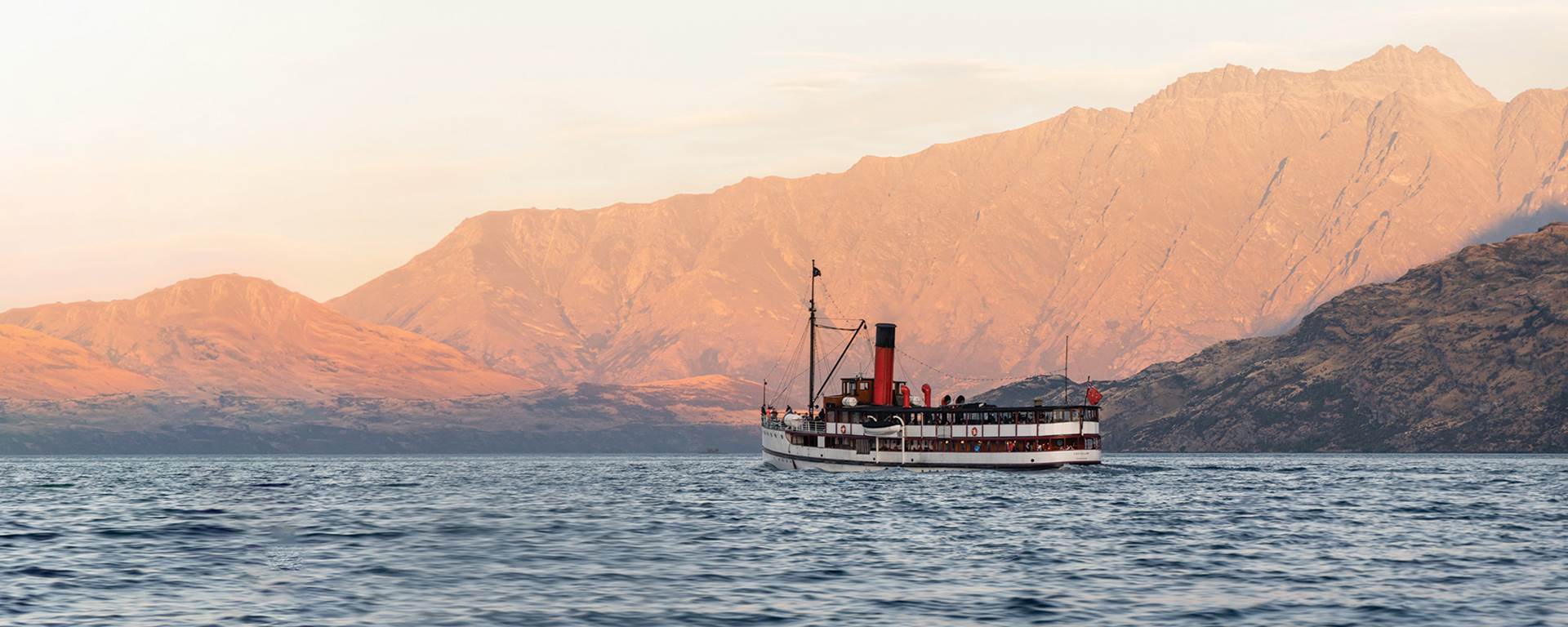 The Tss Earnslaw sails in front of the Remarkables